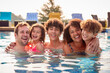 © Monkey Business - Portrait Of Family Having Fun In Swimming Pool On Summer Vacation