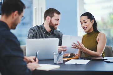 Poster - Executing their plans to the detail. Shot of a group of young designers having a discussion in an office.