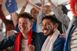 © Halfpoint - French football fans celebrating their team's victory at stadium.
