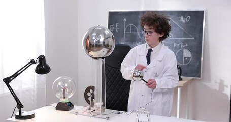 Wall Mural - education, science and kids concept - boy wearing goggles for physics lab doing electrical tests. ch