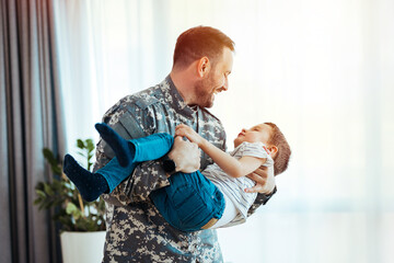 Happy soldier play with his son. Soldier enjoying at home with children. My Hero is back home. Little boy meeting his military father at home. Memorial Day celebration..