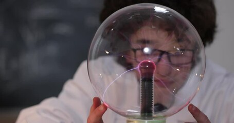 Wall Mural - education, science and kids concept - boy wearing goggles for physics lab doing electrical tests. ch