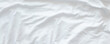 © jes2uphoto - White wrinkled fabic texture rippled surface wide background,Close up unmade bed sheet in the bedroom after night sleep Soft focus
