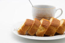 Some Slices Of Pound Cake In A Plate In White Background With A Cup Of Tea