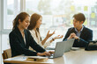 © Phushutter - Three young Asian businesswomen and businessman at the meeting in a conference room.