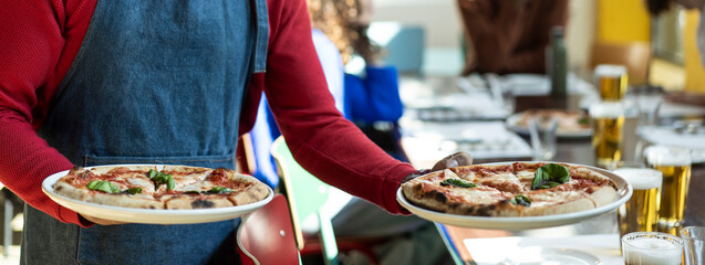 waiter serving delicious pizza in cozy pizzeria restaurant - italian pizza in italian restaurant - h