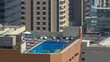 © HyperlapsePro - Rooftop swimming pool viewed from above timelapse, Aerial top view at financial district. Dubai, UAE