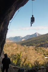 Wall Mural - the climber hangs on a rope in a cave