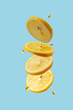 lemon slices fly on a blue background