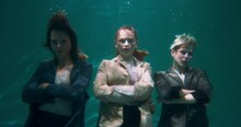 Fun Boss Businesswoman Concept. Three Young Beautiful Women Posing Serious, Then Laughing Happy Underwater Slow Motion.