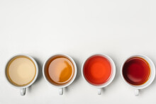 Top View Of Cups Of Tea On White Background With Copy Space.