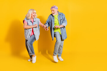 Wall Mural - Photo of sweet adorable husband wife wear jeans shirts dancing empty space isolated yellow color background