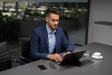 Wall Mural - Handsome middle eastern entrepreneur working at modern office