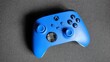 Blue game controller isolated on black surface
