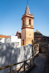 Wall Mural - Bell tower of the church of Santa María de la Mesa built in the 18th century in baroque style in the white town of Zahara de la Sierra, Cadiz province, Andalusia, Spain