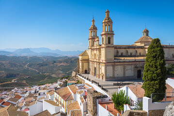 Wall Mural - View of the beautiful white village of Olvera with the Church of Our Lady of the Incarnation, 18th century, in neoclassical style in the upper part of the city, Cadiz province, Andalusia, Spain