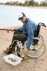 Canvas Print - Man in wheelchair fishing on river