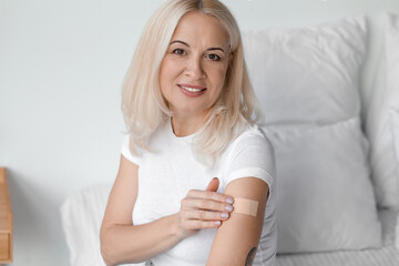 mature woman with applied nicotine patch at home. smoking cessation