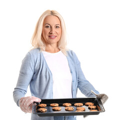 Wall Mural - Mature woman holding baking dish with cookies on white background