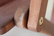 Detail of wooden movable joint of the chair armrest with screw fixed from the side.