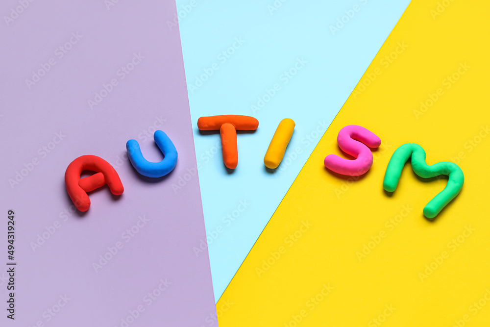 Word AUTISM on colorful background