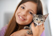 © Alexandra/peopleimages.com - Can we keep him. A happy young girl holding a kitten affectionately.