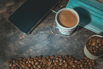 Canvas Print - Closeup shot of a cup of coffee, beans and a medical mask