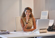 © Yuri A/peopleimages.com - She always gets the job done with a smile. Portrait of a businesswoman sitting at her desk working on a laptop.