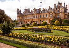 External View Of The Waddesdon Manor With Surrounding Greenery Against A Cloudy Sky In England