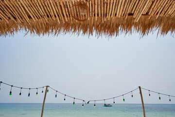 Wall Mural - Beach view to the blue sky and water nd electric lamps in foreground