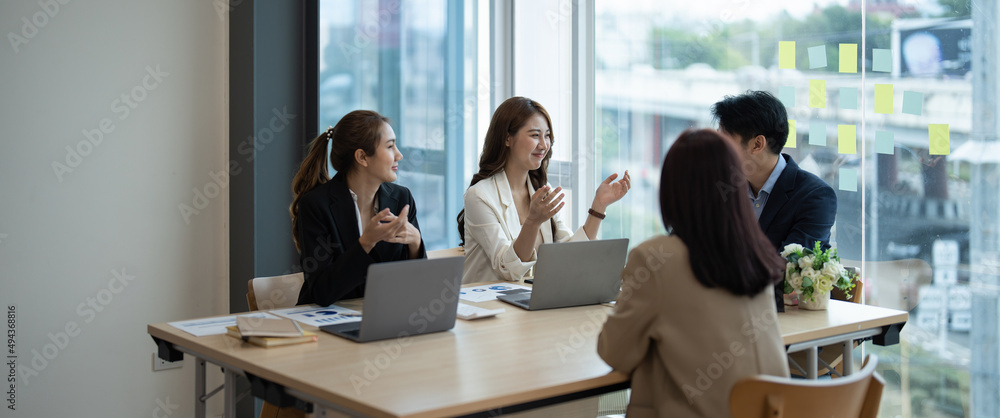 Group of young asian business people brainstorming at a meeting ...
