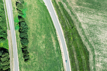 Wall Mural - asphalt roads pass through green countryside landscape. aerial overhead view.