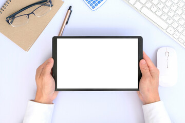 Canvas Print - Top view image of white workspace is surrounding by a white blank screen tablet and various equipment