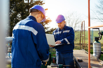 Wall Mural - Two engineers working inside oil and gas refinery