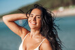 © Syda Productions - people, summer and swimwear concept - happy smiling young woman in bikini swimsuit on beach