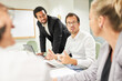 © Robert Kneschke - Business people working together on laptop computer