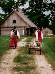 Latvian folk girls in traditional costume. Latvia summer. Symbolism of Latvia for Ligo holiday. Midsummer in Latvia. Traditional Latvian midsummer food. Celebration of Ligo in june decorating home wit