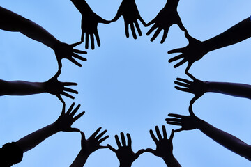 Poster - Collaborating as one. Shot of a group of hands spread out together in a circle.