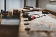 © flordigitalartist - Collection of vintage woodworking tools on a rough workbench and blank copy space: carpentry, craftsmanship and handwork concept, flat lay