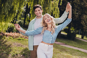 Wall Mural - Portrait of two attractive cheerful carefree couple enjoying springtime weekend pastime daydream on fresh air village outdoors