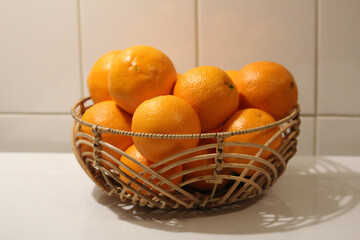 Closeup of a pile of oranges in a basket