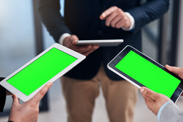 Leinwandbilder - The digital era gets more done. Cropped shot of a group of businesspeople using their digital tablets during a collaboration.
