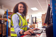 © Monkey Business - Portrait Of Female Worker In Busy Modern Warehouse Working On Computer Terminal