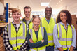 © Monkey Business - Portrait Of Multi-Cultural Team Wearing Hi-Vis Safety Clothing Working In Modern Warehouse