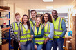 © Monkey Business - Portrait Of Multi-Cultural Team Wearing Hi-Vis Safety Clothing Working In Modern Warehouse