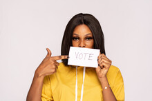 Young African Lady Holding A Card With Vote Written