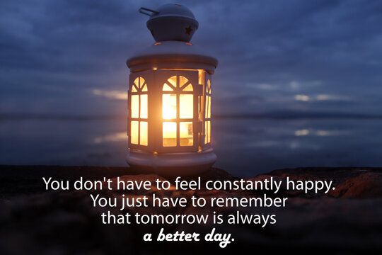 Wall Mural -  - Inspirational quote - You don't have to feel constantly happy. You just have to remember that tomorrow is always a better day. With lantern light on the beach at night. Hope concept.