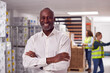 © Monkey Business - Portrait Of Team Male Leader In Warehouse With Staff Picking Items From Shelves In Background
