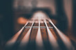 © Ben G1/Wirestock Creators - Closeup shot of a bass guitar strings against a blurred background