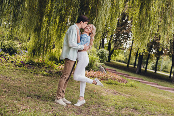 Poster - Full length body size view of two attractive cheerful amorous couple kissing hugging enjoying honeymoon on fresh air outdoors